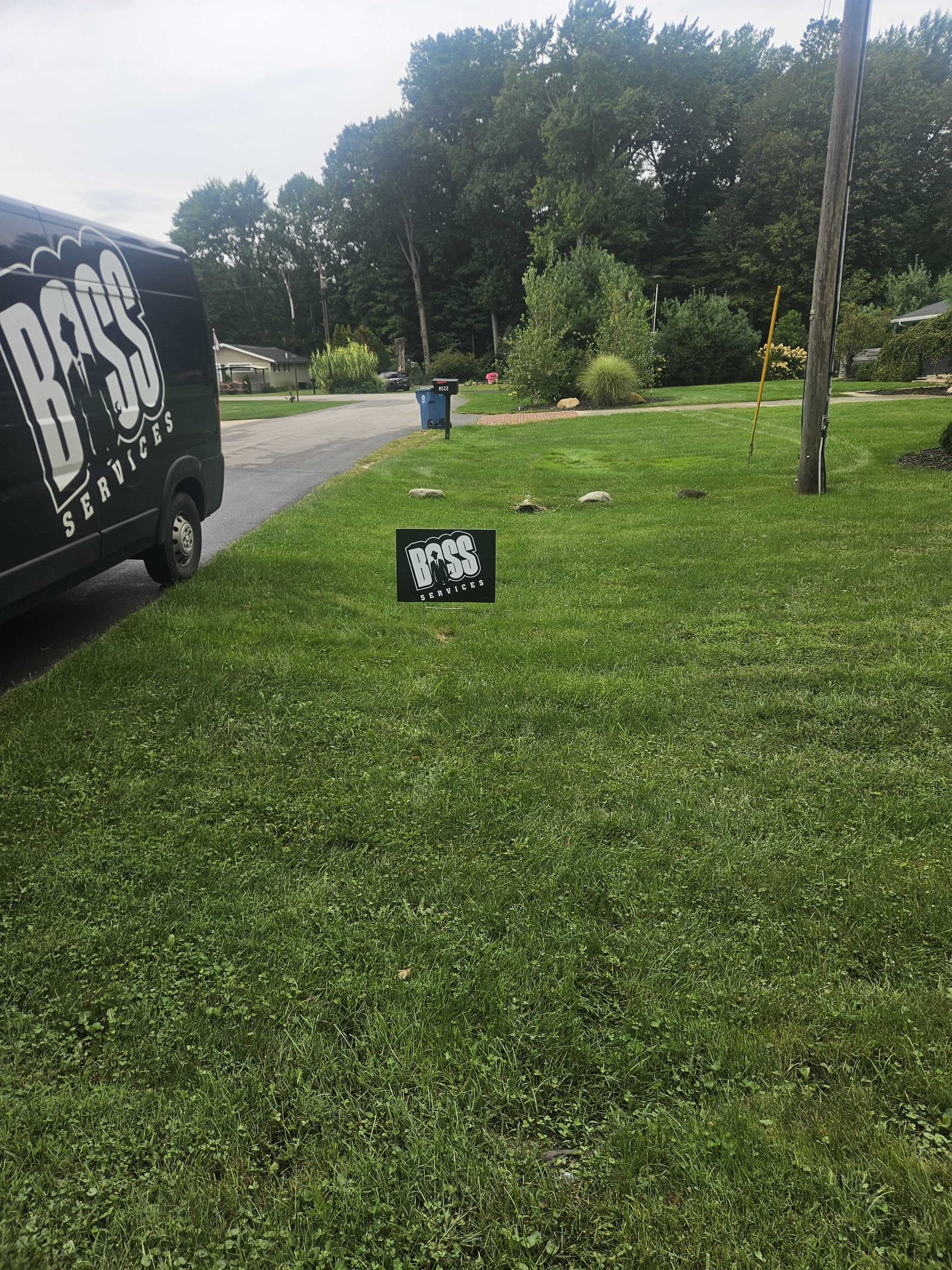 Boss Services van and yard sign on a local job